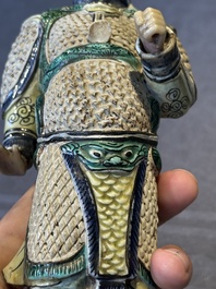 A fine Chinese verte biscuit figure of a warrior on wooden stand, Kangxi