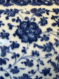 A Chinese blue and white 'flower scroll' jar with a wooden cover, Qianlong