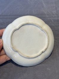 A Chinese blue and white 'butterfly' cup and saucer with applied floral design, Qianlong