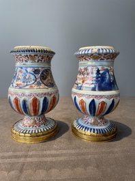 A pair of Chinese Imari-style casters or vases with gilt bronze mounts, Kangxi