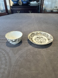 A Chinese gilt-decorated grisaille armorial cup and saucer, Qianlong