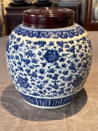 A Chinese blue and white 'flower scroll' jar with a wooden cover, Qianlong