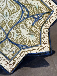 An intact Kashan lustre-glazed star tile, Persia, 13/14th C.