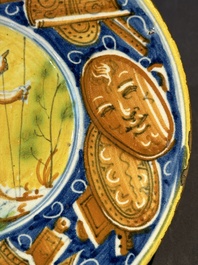 A polychrome Italian maiolica plate with a putto surrounded by trophies, Pesaro, 16th C.