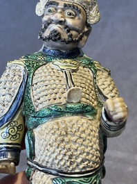 A fine Chinese verte biscuit figure of a warrior on wooden stand, Kangxi