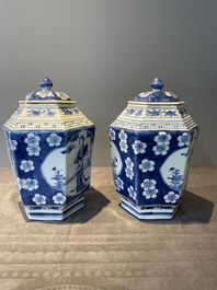 A pair of Chinese blue and white hexagonal jars and covers with a lady holding a fan, 19th C.