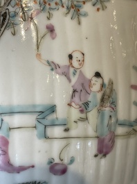 A pair of Chinese famille rose jars and covers with figures in a garden, Tongzhi mark and of the period