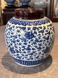 A Chinese blue and white 'flower scroll' jar with a wooden cover, Qianlong