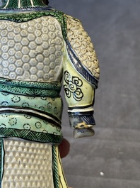 A fine Chinese verte biscuit figure of a warrior on wooden stand, Kangxi