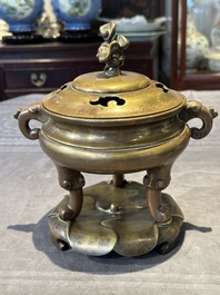 A Chinese bronze tripod censer with cover and stand, 19th C.