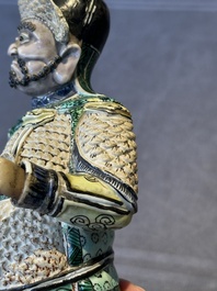 A fine Chinese verte biscuit figure of a warrior on wooden stand, Kangxi