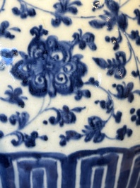 A Chinese blue and white 'flower scroll' jar with a wooden cover, Qianlong