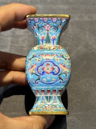 A Chinese Canton enamel 'gu' vase with floral design, Qianlong mark and of the period