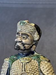A fine Chinese verte biscuit figure of a warrior on wooden stand, Kangxi