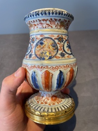 A pair of Chinese Imari-style casters or vases with gilt bronze mounts, Kangxi