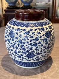 A Chinese blue and white 'flower scroll' jar with a wooden cover, Qianlong