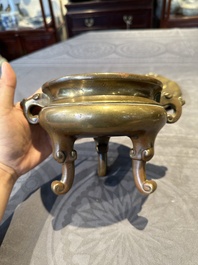 A Chinese bronze tripod censer with cover and stand, 19th C.