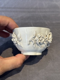 A Chinese blue and white 'butterfly' cup and saucer with applied floral design, Qianlong