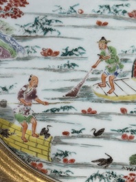 A Chinese famille rose plate with figures in a river landscape in gilt wooden frame, Yongzheng
