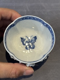 A Chinese blue and white 'butterfly' cup and saucer with applied floral design, Qianlong
