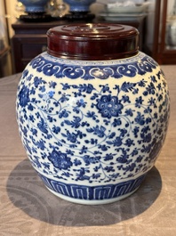 A Chinese blue and white 'flower scroll' jar with a wooden cover, Qianlong