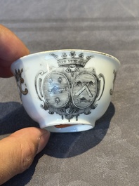 A Chinese gilt-decorated grisaille armorial cup and saucer, Qianlong