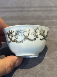 A Chinese gilt-decorated grisaille armorial cup and saucer, Qianlong