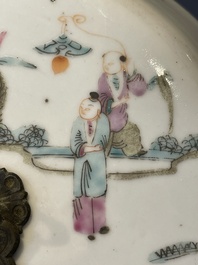 A pair of Chinese famille rose jars and covers with figures in a garden, Tongzhi mark and of the period