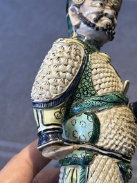 A fine Chinese verte biscuit figure of a warrior on wooden stand, Kangxi