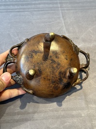 Two Chinese Chinese bronze cylindrical incense stick holders and a covered censer, Yuan/Ming and Qing