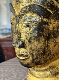 A Thai red sandstone head of Buddha and a lacquered and gilt stone head of Buddha, possibly Ayutthaya period, 15th C.