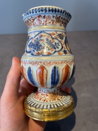 A pair of Chinese Imari-style casters or vases with gilt bronze mounts, Kangxi