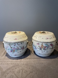 A pair of Chinese famille rose jars and covers with figures in a garden, Tongzhi mark and of the period