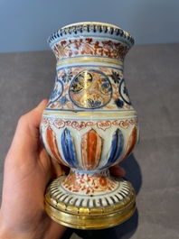A pair of Chinese Imari-style casters or vases with gilt bronze mounts, Kangxi