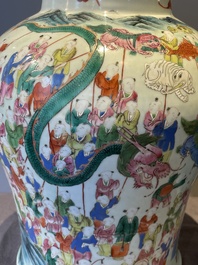 A pair of Chinese famille rose 'hundred boys' vases and covers on wooden stands, 19th C.