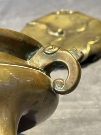 A Chinese bronze tripod censer with cover and stand, 19th C.