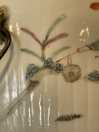 A pair of Chinese famille rose jars and covers with figures in a garden, Tongzhi mark and of the period