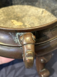A Chinese bronze tripod censer with cover and stand, 19th C.
