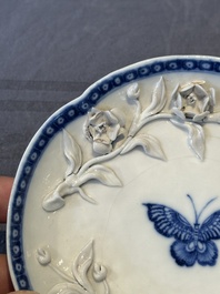 A Chinese blue and white 'butterfly' cup and saucer with applied floral design, Qianlong