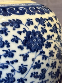 A Chinese blue and white 'flower scroll' jar with a wooden cover, Qianlong