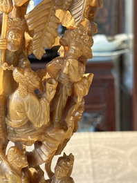 A Chinese buffalo horn carving of a landscape with a pagoda on wooden stand, Qing
