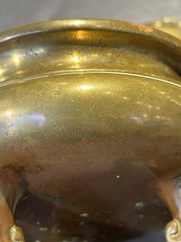 A Chinese bronze tripod censer with cover and stand, 19th C.