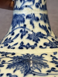 A Chinese blue and white 'lotus scroll' bottle vase, 18/19th C.