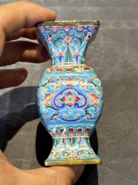 A Chinese Canton enamel 'gu' vase with floral design, Qianlong mark and of the period