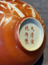 A Chinese coral-red-glazed bowl with reverse-decorated bamboo design, Xuantong mark and of the period