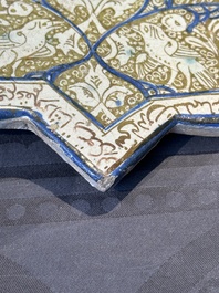An intact Kashan lustre-glazed star tile, Persia, 13/14th C.