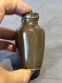 A rare Chinese monochrome teadust-glazed snuff bottle with a bronze 'dragon' stopper, 18/19th C.