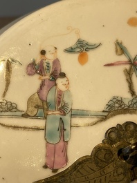 A pair of Chinese famille rose jars and covers with figures in a garden, Tongzhi mark and of the period