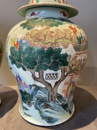 A pair of Chinese famille rose 'hundred boys' vases and covers on wooden stands, 19th C.