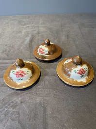 A Chinese capucin-brown-ground famille rose garniture of five vases with floral design, Qianlong